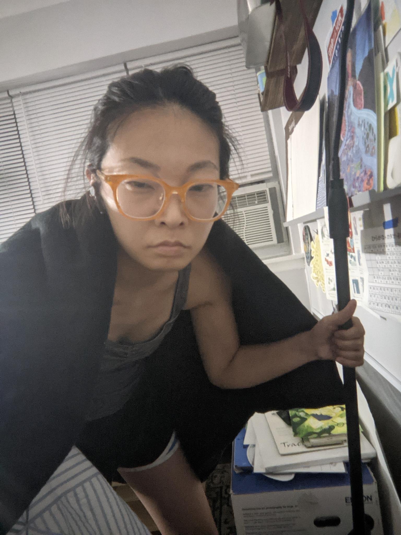 picture of me in 2021 posing as an onibaba, hunched over, holding a walking stick