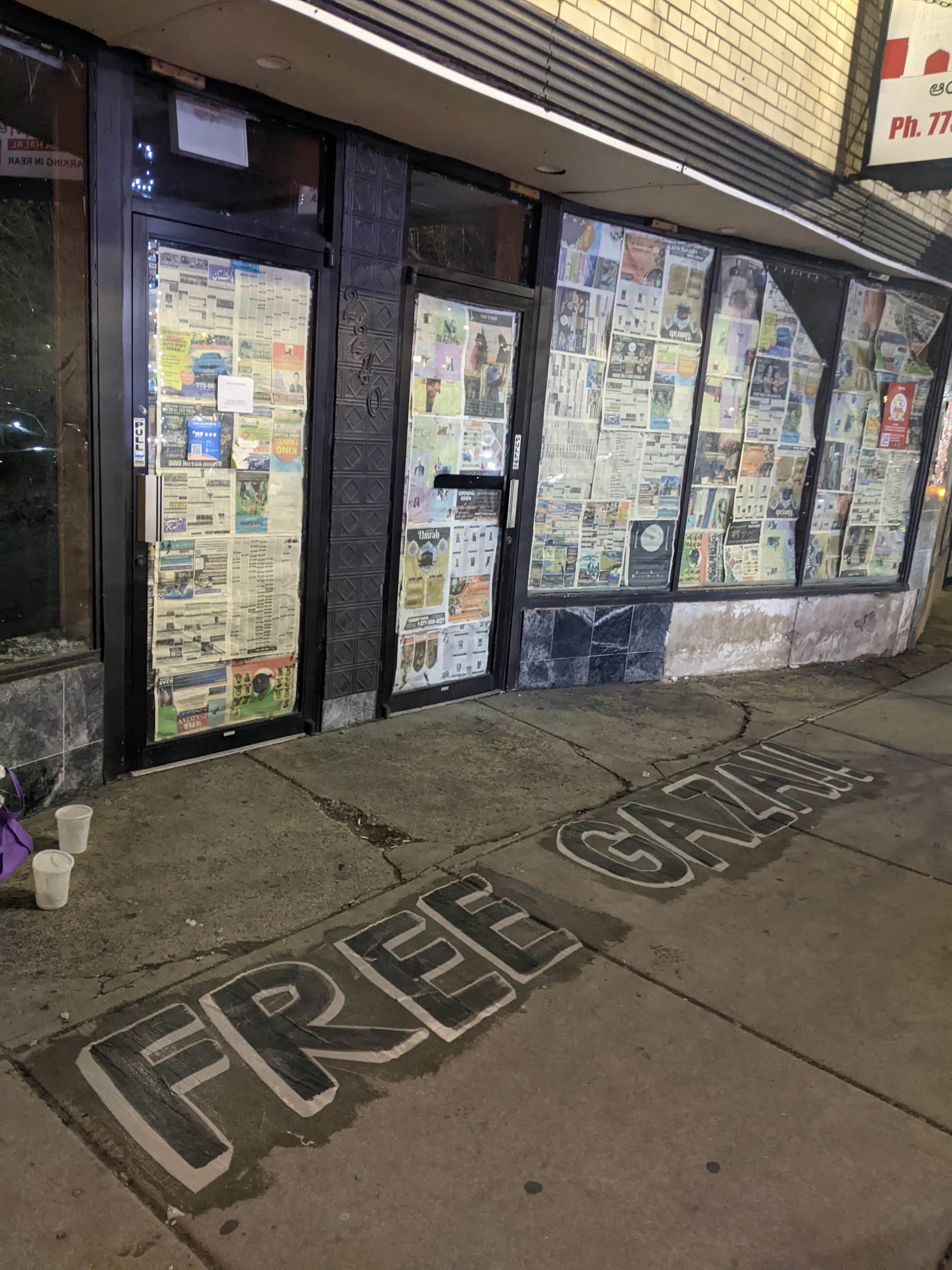 photo of the words 'free gaza' wheatpasted on the sidewalk